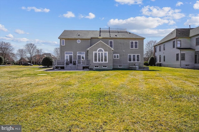 rear view of property featuring a yard, central AC, and a patio area