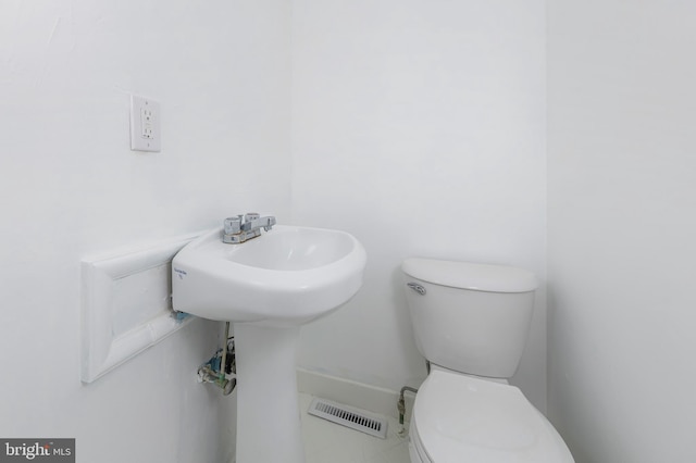 bathroom with visible vents and toilet