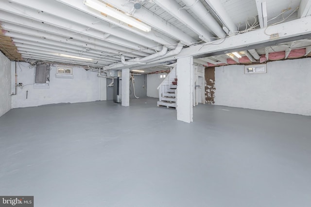 basement featuring electric panel and stairs