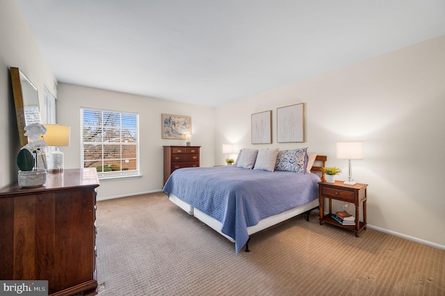 carpeted bedroom featuring baseboards