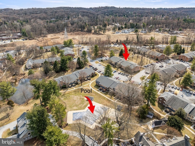 drone / aerial view with a residential view and a wooded view