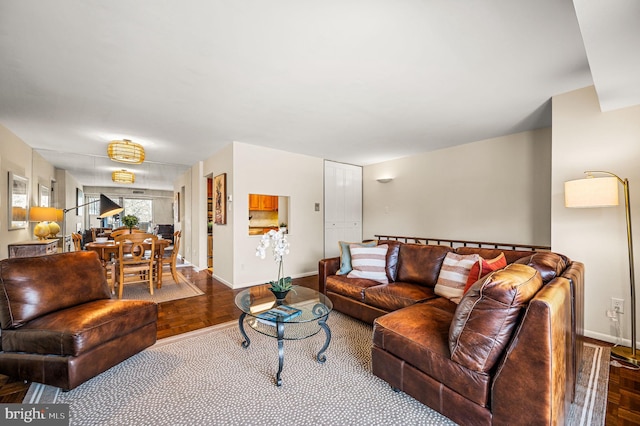 living area featuring baseboards