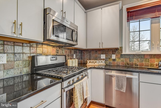 kitchen featuring tasteful backsplash, white cabinets, and appliances with stainless steel finishes