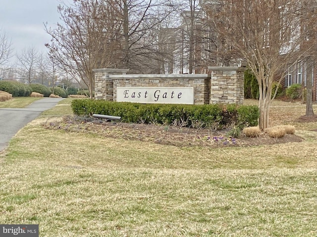 community sign featuring a lawn