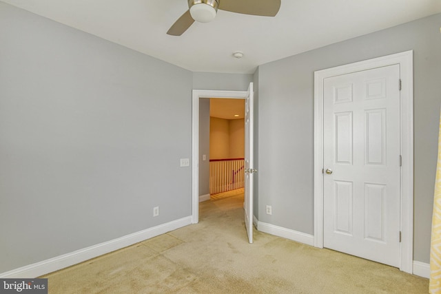 unfurnished bedroom featuring baseboards, ceiling fan, and carpet flooring