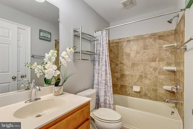 full bath featuring visible vents, toilet, shower / bath combo with shower curtain, and vanity