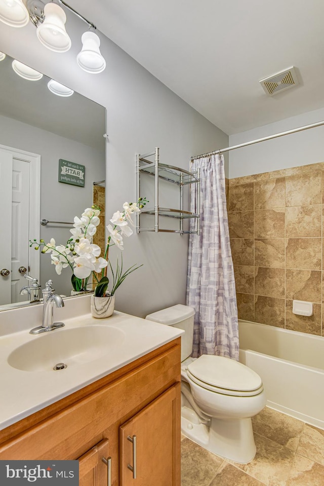 bathroom with vanity, shower / tub combo, toilet, and visible vents