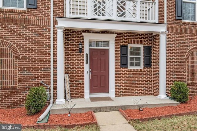 property entrance with brick siding