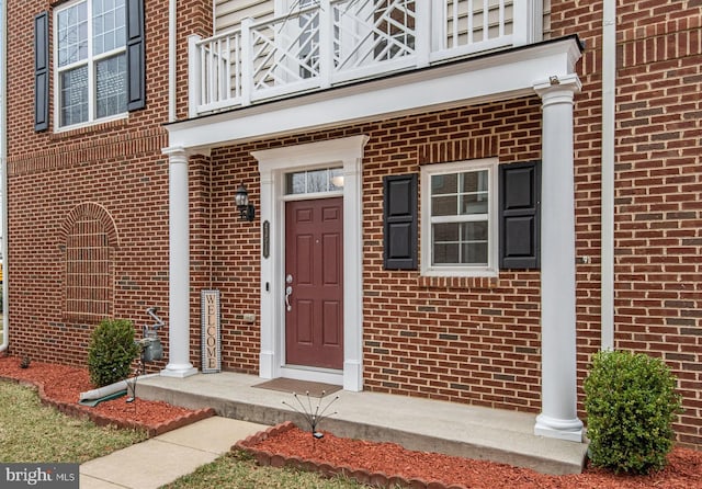 property entrance with brick siding