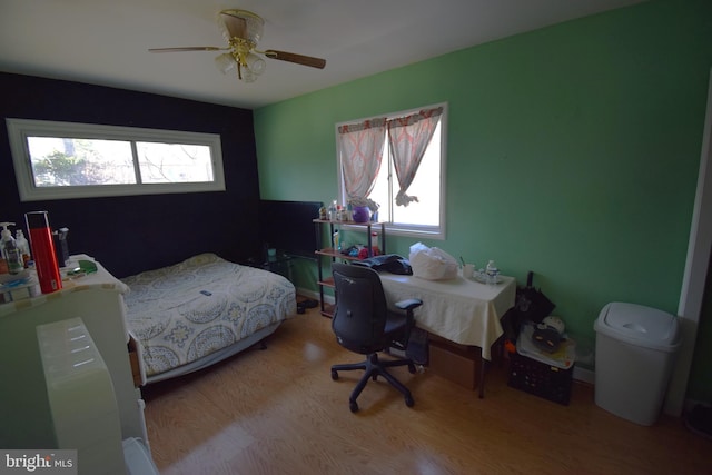 bedroom with ceiling fan and wood finished floors