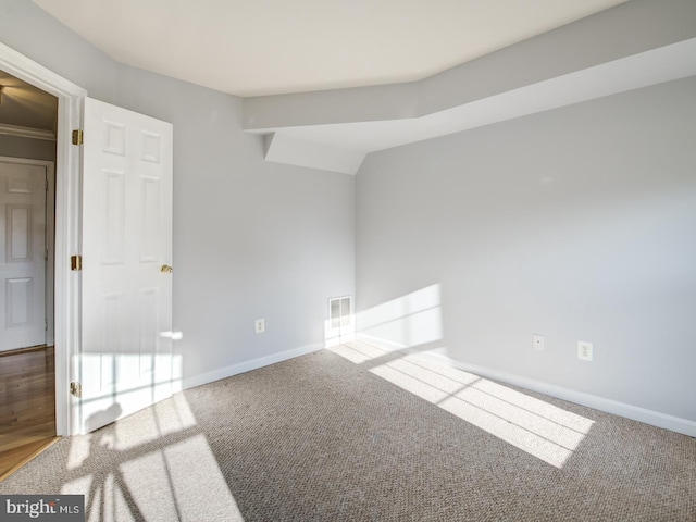 carpeted empty room featuring visible vents and baseboards