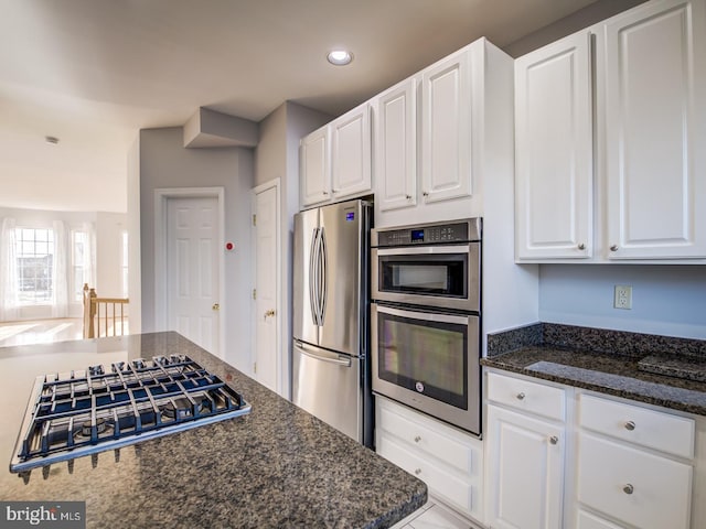 kitchen featuring white cabinetry, dark stone counters, recessed lighting, and appliances with stainless steel finishes