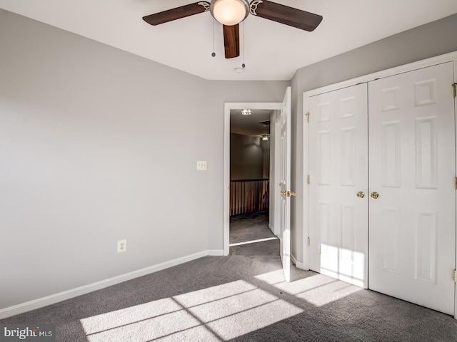 unfurnished bedroom with a closet, baseboards, carpet floors, and ceiling fan