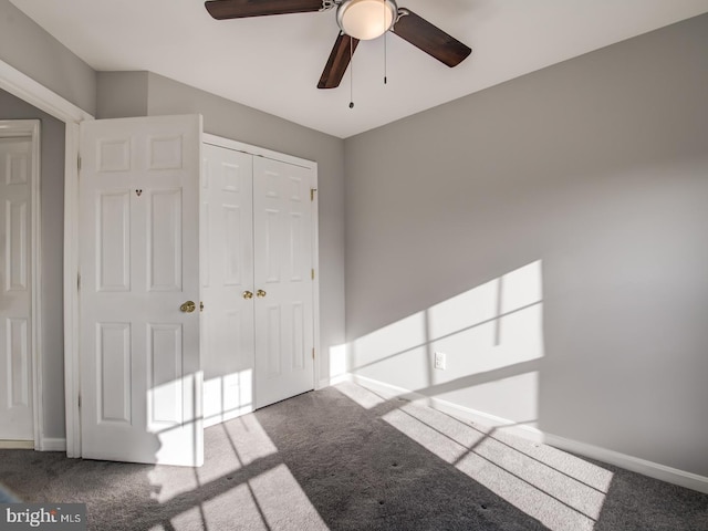 unfurnished bedroom featuring a closet, baseboards, and carpet