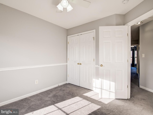 unfurnished bedroom with carpet, baseboards, a closet, and ceiling fan