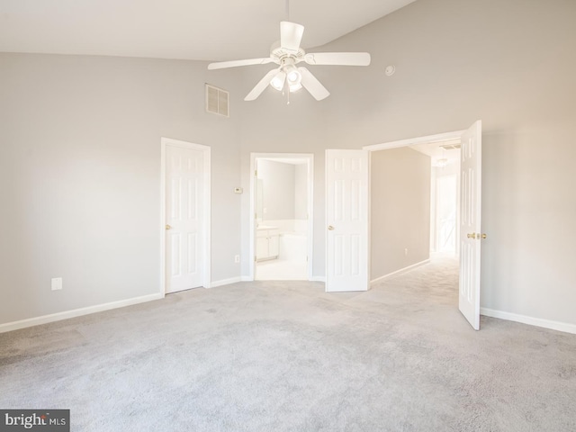 unfurnished bedroom featuring high vaulted ceiling, carpet, visible vents, and baseboards