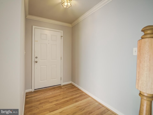 doorway to outside with crown molding, light wood-style floors, and baseboards