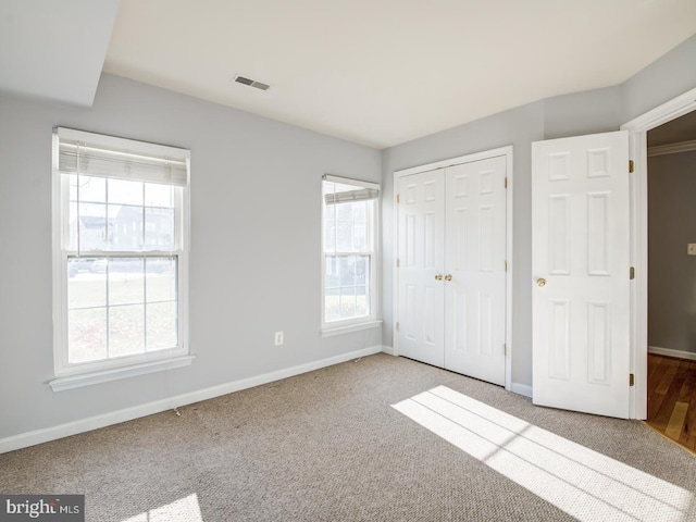 unfurnished bedroom with multiple windows and baseboards