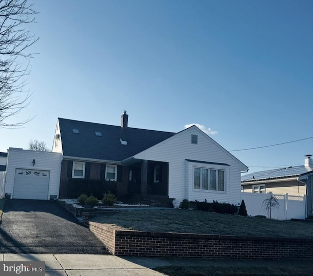 25 Wesleyan Dr, Hamilton, NJ 08690 - view of front of home with fence, driveway, a chimney, and a garage