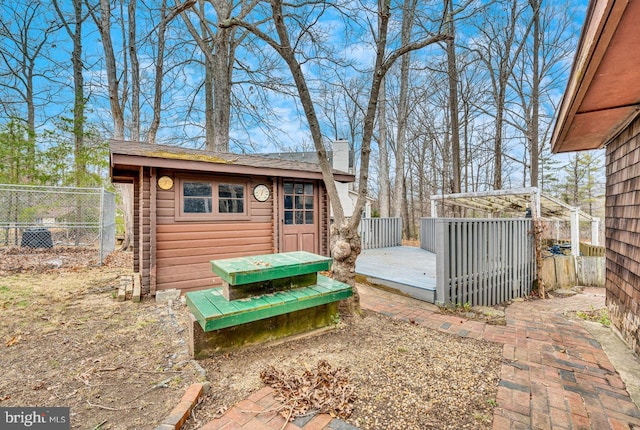 view of outbuilding with an outdoor structure and fence