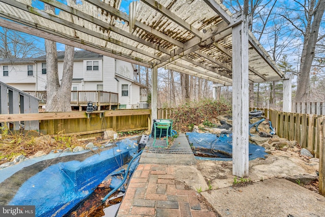 view of patio featuring a pergola and fence