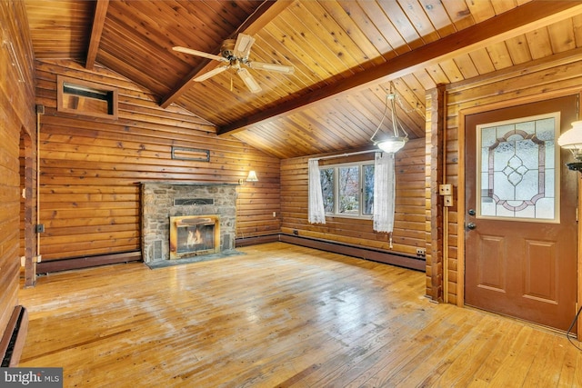 unfurnished living room with hardwood / wood-style floors, lofted ceiling with beams, ceiling fan, a stone fireplace, and a baseboard heating unit