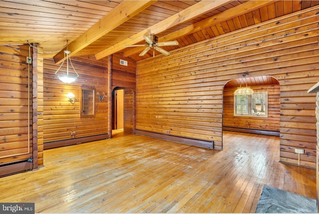 unfurnished living room with beam ceiling, arched walkways, ceiling fan, wood-type flooring, and baseboard heating