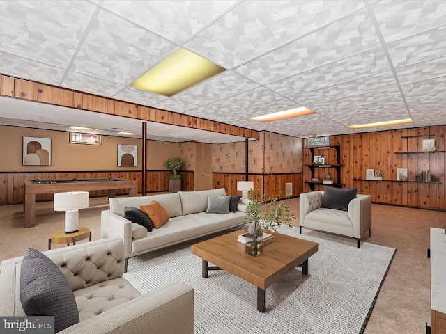 carpeted living room featuring pool table, wooden walls, and wainscoting