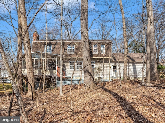 back of property featuring a chimney