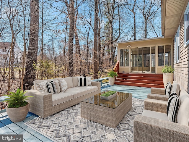 exterior space with an outdoor hangout area, entry steps, a patio, and a sunroom