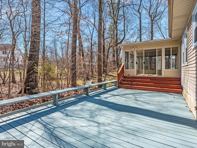 wooden deck with a sunroom