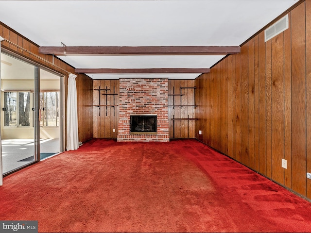 unfurnished living room with visible vents and wooden walls