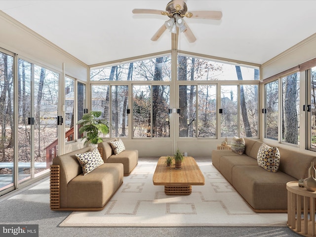 sunroom with lofted ceiling and a ceiling fan