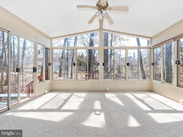 unfurnished sunroom with ceiling fan and vaulted ceiling