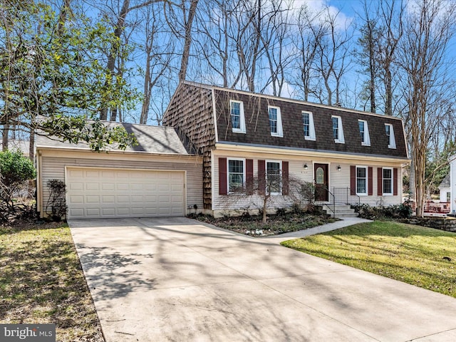 view of front facade featuring a front lawn, concrete driveway, a garage, and roof with shingles