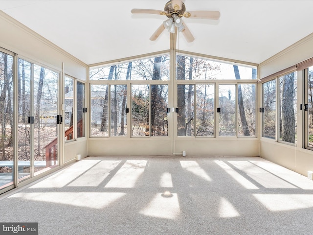 unfurnished sunroom featuring a ceiling fan and vaulted ceiling