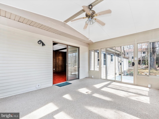 unfurnished sunroom with a ceiling fan and vaulted ceiling