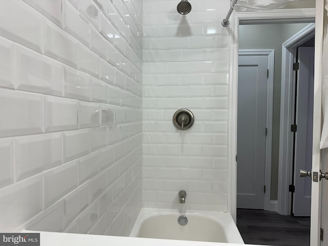 full bathroom featuring shower / tub combination and wood finished floors