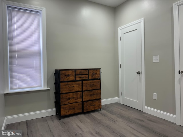 bedroom featuring baseboards and wood finished floors