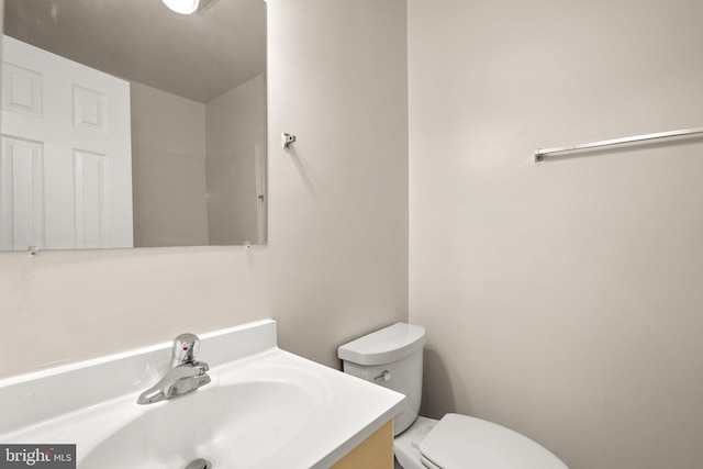 bathroom with toilet and vanity