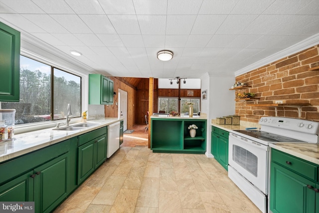 kitchen featuring a sink, light countertops, ornamental molding, white appliances, and green cabinetry