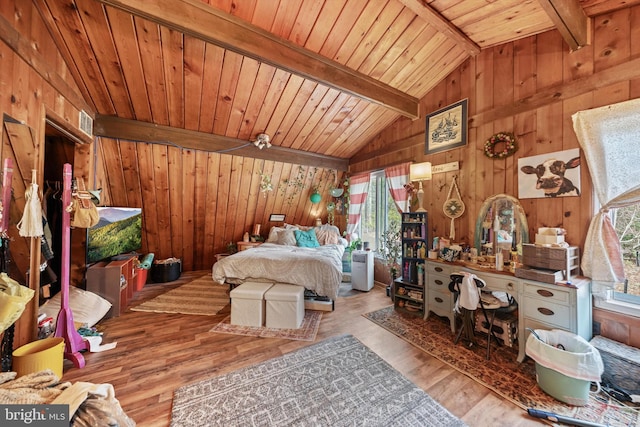 bedroom with wood ceiling, wooden walls, vaulted ceiling with beams, and wood finished floors