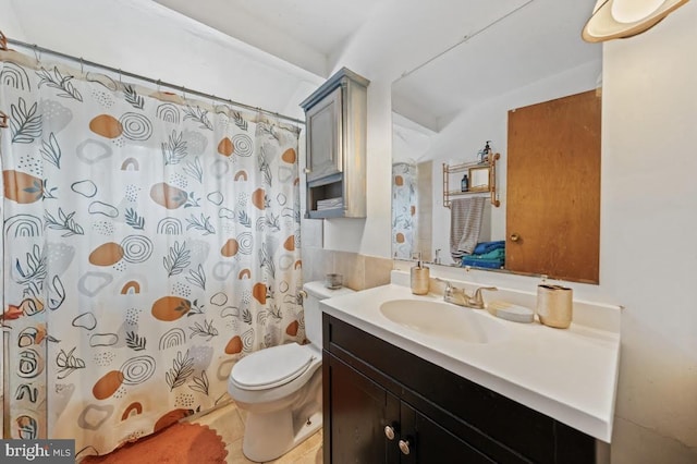 bathroom with vanity, curtained shower, and toilet