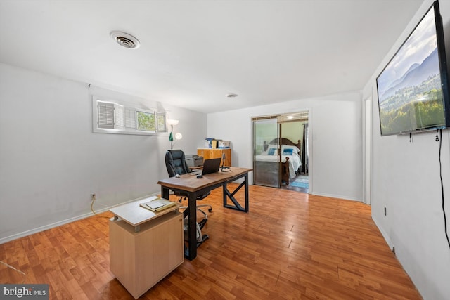 office space with visible vents, baseboards, and light wood finished floors