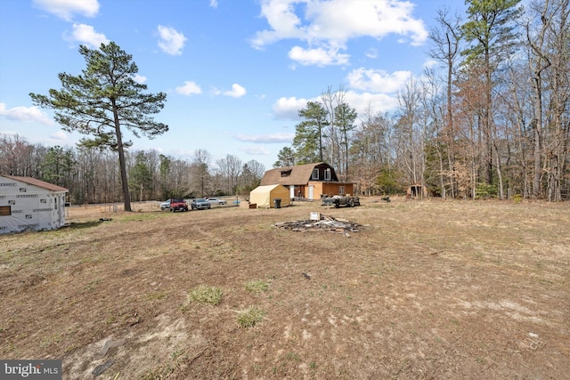 view of yard with a barn and an outbuilding