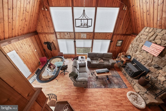 living area featuring an inviting chandelier and wood walls