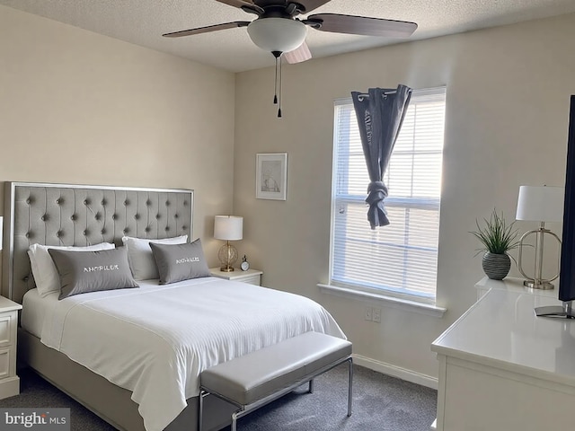 carpeted bedroom with baseboards, a textured ceiling, and ceiling fan