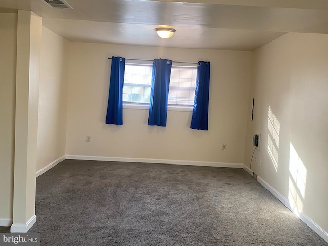 spare room with baseboards, carpet floors, and visible vents