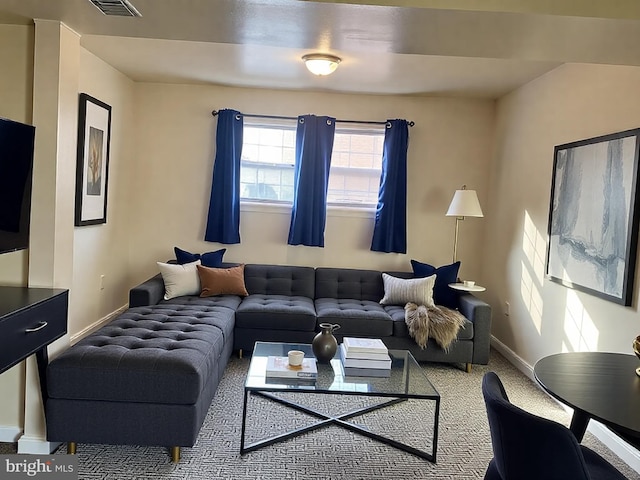 living room featuring visible vents, baseboards, and carpet