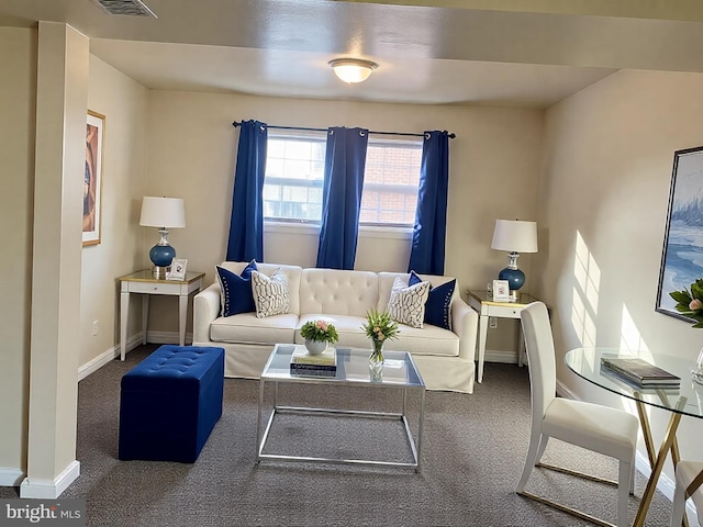 carpeted living room with visible vents and baseboards